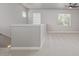 Loft area with neutral carpeting, windows for natural light, and a railing overlooking the lower level at 3710 E Cheery Lynn Rd, Phoenix, AZ 85018