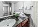 Bathroom with a dark brown vanity cabinet and a white sink at 3825 E Camelback Rd # 152, Phoenix, AZ 85018