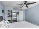 Bedroom with a ceiling fan, a mirrored closet, and blue walls at 3825 E Camelback Rd # 152, Phoenix, AZ 85018