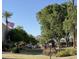 Beautifully landscaped courtyard with mature trees, green grass, and mountain views at 3825 E Camelback Rd # 152, Phoenix, AZ 85018