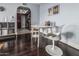 Dining area with dark wood floors, decorative painting, and modern, minimalist furnishing at 3825 E Camelback Rd # 152, Phoenix, AZ 85018