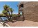 Exterior of stucco condo building with landscaping, bougainvillea, and parking area at 3825 E Camelback Rd # 152, Phoenix, AZ 85018