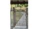 An ornate metal gate providing access to a lawn and garden area at 3825 E Camelback Rd # 152, Phoenix, AZ 85018