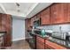 Cozy kitchen with stainless steel appliances, dark granite countertops and wood cabinets at 3825 E Camelback Rd # 152, Phoenix, AZ 85018