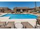 Exterior view of a large community pool with tanning chairs at 3825 E Camelback Rd # 152, Phoenix, AZ 85018