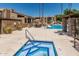A community pool with lounge chairs and well-maintained landscaping at 3825 E Camelback Rd # 152, Phoenix, AZ 85018