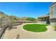Beautiful backyard showcasing lush green lawn, desert landscaping, and covered patio, offering a tranquil outdoor space at 3903 E Melody Dr, Phoenix, AZ 85042
