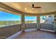 Relaxing covered balcony framed by stone pillars, offering panoramic views of the desert landscape and distant city skyline at 3903 E Melody Dr, Phoenix, AZ 85042