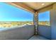 A cozy balcony with stone accents offers a stunning, unobstructed view of the surrounding desert landscape at 3903 E Melody Dr, Phoenix, AZ 85042