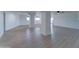 Expansive basement featuring wood-look flooring, bright white walls, and structural support columns at 3903 E Melody Dr, Phoenix, AZ 85042