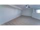 Basement with vinyl floors, ceiling fan, and natural light from a nearby window at 3903 E Melody Dr, Phoenix, AZ 85042