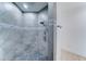 Tiled shower with rainfall shower head and pebble tile floor at 3903 E Melody Dr, Phoenix, AZ 85042