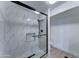 Bathroom with modern walk-in shower featuring black trim and niche; offers a sleek design at 3903 E Melody Dr, Phoenix, AZ 85042