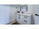 Bathroom vanity with white cabinets, black hardware, and quartz countertops, creating a modern look at 3903 E Melody Dr, Phoenix, AZ 85042