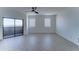 Bright bedroom features sliding glass door to balcony, modern ceiling fan and two windows at 3903 E Melody Dr, Phoenix, AZ 85042