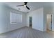 Bright bedroom features sleek ceiling fan and includes a closet for storage and convenience at 3903 E Melody Dr, Phoenix, AZ 85042