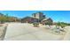 Exterior view of a home with a large driveway, three-car garage, and desert surroundings at 3903 E Melody Dr, Phoenix, AZ 85042