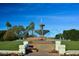 A majestic multi-tiered fountain surrounded by manicured lawns and vibrant flowerbeds at 3903 E Melody Dr, Phoenix, AZ 85042