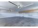 Spacious two-car garage with ample room for vehicles and storage; features overhead lighting at 3903 E Melody Dr, Phoenix, AZ 85042