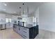 Modern kitchen featuring large black marble island, stainless appliances, and bright white cabinetry and countertops at 3903 E Melody Dr, Phoenix, AZ 85042