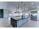 Open floor plan with gourmet kitchen featuring black marble island, gas range, and bright stainless steel appliances at 3903 E Melody Dr, Phoenix, AZ 85042