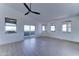 Bright living room with sliding glass doors, multiple windows, ceiling fan and beautiful light wood floors at 3903 E Melody Dr, Phoenix, AZ 85042