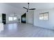 Expansive living space with a fireplace feature, ample natural light, and ceiling fans at 3903 E Melody Dr, Phoenix, AZ 85042
