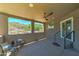 Covered patio with scenic views of the hills, featuring a comfortable seating area and easy access from sliding glass doors at 3903 E Melody Dr, Phoenix, AZ 85042