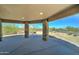 Covered patio featuring stone columns, a concrete floor, and desert views at 3903 E Melody Dr, Phoenix, AZ 85042
