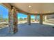 Spacious covered patio with stone columns and desert scenery at 3903 E Melody Dr, Phoenix, AZ 85042