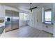 Bright room with stainless steel refrigerator, built in cabinets, and window with desert views at 3903 E Melody Dr, Phoenix, AZ 85042