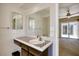 Bathroom features a vanity with a large mirror and a view to the bedroom's sliding glass doors at 4032 E Cannon Dr, Phoenix, AZ 85028