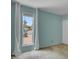Light-filled bedroom with a window view and pale blue accent wall exudes serenity at 4032 E Cannon Dr, Phoenix, AZ 85028