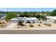 Stylish home featuring solar panels, desert landscaping, and an inviting arched entryway at 4032 E Cannon Dr, Phoenix, AZ 85028