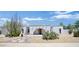 Charming single-story home with unique desert landscaping, featuring cacti and a decorative arched entrance at 4032 E Cannon Dr, Phoenix, AZ 85028