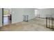 Open-concept living room showcasing neutral carpet and access to the kitchen with breakfast bar at 4032 E Cannon Dr, Phoenix, AZ 85028