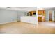 Spacious living area with tile floors adjoining an open kitchen with bar seating at 4032 E Cannon Dr, Phoenix, AZ 85028