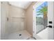 Bright bathroom featuring glass enclosed shower and access to outdoor pool area at 4079 E Yucca St, Phoenix, AZ 85028