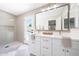 Bright bathroom featuring double sinks, white cabinetry, and access to outdoor pool area at 4079 E Yucca St, Phoenix, AZ 85028