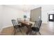 Inviting dining room showcases a rustic wooden table with black chairs and modern chandelier lighting at 4079 E Yucca St, Phoenix, AZ 85028