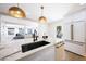 Stylish kitchen island with marble countertops, a sleek faucet, and an open view to the living area at 4079 E Yucca St, Phoenix, AZ 85028