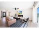 Bright living room boasts modern fireplace, sleek ceiling fan, and access to outdoor pool area at 4079 E Yucca St, Phoenix, AZ 85028