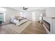 Relaxing main bedroom features a modern fireplace, ceiling fan and bright natural light at 4079 E Yucca St, Phoenix, AZ 85028