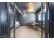 A home office boasts modern lighting, neutral walls, hardwood floors, a wood desk and a gray loveseat at 4079 E Yucca St, Phoenix, AZ 85028