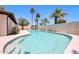 A clear pool is surrounded by palm trees and desert landscaping, on a sunny day at 4079 E Yucca St, Phoenix, AZ 85028