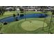 Beautiful aerial view of the golf course with lush green fairways, pond, and palm trees at 4151 E Clovis Ave, Mesa, AZ 85206