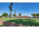 Picturesque golf course view with lush green fairways, palm trees, and a clubhouse under a clear blue sky at 4151 E Clovis Ave, Mesa, AZ 85206