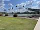 Inviting tennis court surrounded by lush greenery and palm trees under a bright sky at 4151 E Clovis Ave, Mesa, AZ 85206