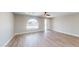Well-lit living room with wood-look floors, white trim, and a bright window at 4151 E Clovis Ave, Mesa, AZ 85206