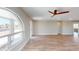 Bright and spacious living room featuring new flooring and a decorative ceiling fan at 4151 E Clovis Ave, Mesa, AZ 85206